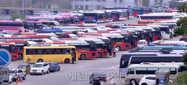 멈춰선 관광버스  메르스 후폭풍이 여전히 가라앉지 않고 있다. 메르스 여파로 인해 약 2만여명의 외국인관광객이 한국 방문을 취소한 가운데 9일 오전 서울 잠실동 탄천주차장에 운행을 하지 않는 관광버스가 주차돼 있다.  이상섭 기자/babtong@heraldcorp.com