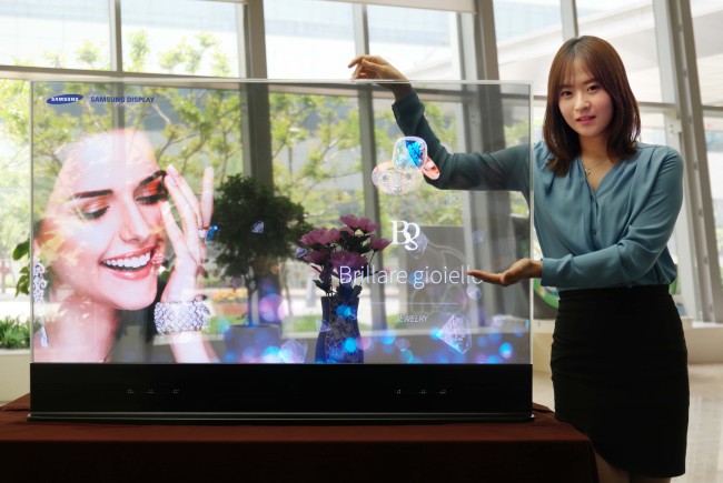Samsung Display on Wednesday unveiled a 55-inch transparent OLED display the first of its kind, featuring 45 percent transparency. The company also showcased augmented reality solutions using the display that it developed in partnership with Intel.    Samsung Display