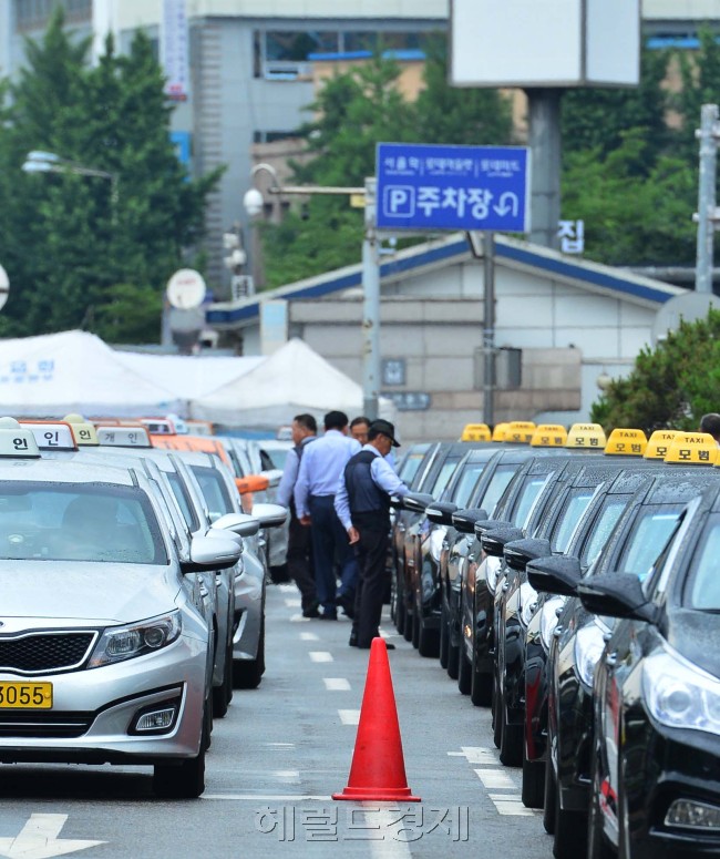 밤거리 택시를 잡는 풍경이 빠르게 바뀌고 있다. 길가에서 택시를 잡는 사람이 줄어든 대신, 앱을 이용해 ‘스마트하게’ 택시를 대령하는 엄지족들이 눈에 띄게 늘었다. 윤병찬 기자/yoon4698@heraldcorp.com