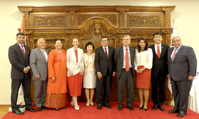 Indian Ambassador Vikram Doraiswami, Turkish Ambassador Arslan Hakan Okcal, Malaysian Ambassador Rohana Ramli, Austrian Ambassador Elisabeth Bertagnoli, CICI president Choi Jung-hwa, Indonesian Ambassador John Prasetio, Spanish Ambassador Gonzalo Ortiz, congresswoman Jasmine Lee, Singaporean Ambassador Wei Kiat Yip and Kuwaiti Ambassador Jasem Albudaiwi pose at a reception at the Indonesian Embassy on Tuesday organized by the Korea CQ Club.   Joel Lee/The Korea Herald