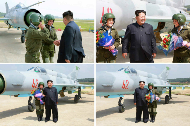 <YONHAP PHOTO-1284> 북한 첫 여성 초음속전투기 조종사 축하하는 김정은 (서울=연합뉴스) 북한에서 처음으로 여성 초음속전투기 비행사가 탄생했다고 노동신문이 22일 보도했다. 그 주인공인 림설(하단 오른쪽 사진)과 조금향(하단 왼쪽사진)이 단독비행 시범 훈련직후 김정은 국방위원회 제1위원장으로부터 직접 축하를 받고 기념사진을 찍고 있다. 조금향과 림설은 지난해 11월 김 제1위원장이 첫 여성 전투기 조종사의 훈련을 참관했을 때 '불사조'라는 치하를 받은 바 있다. 2015.6.22 nkphoto@yna.co.kr/2015-06-22 09:56:26/ <저작권자 ⓒ 1980-2015 ㈜연합뉴스. 무단 전재 재배포 금지.>
North Korean leader Kim Jong-un is seen congratulating and posing for photos with the regime’s first female pilots of supersonic jets during flight training.   Yonhap