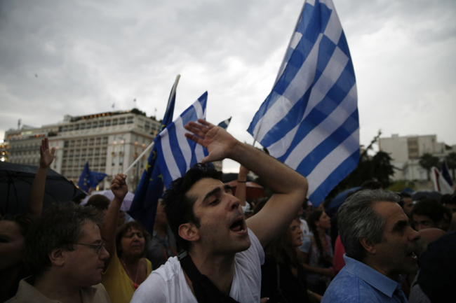 A demonstrator shout slogans during a rally organized by supporters of the YES vote for the upcoming referendum in Athens, Tuesday. (AP-Yonhap)