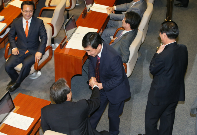 <YONHAP PHOTO-2454> 투표합시다 (서울=연합뉴스) 진성철 기자 = 새정치민주연합 이종걸 원내대표가 6일 국회 본회의에서 새누리당 김무성 대표의 손을 잡고 '국회법 개정안 재의안'에 대해한 투표 참여를 재촉하고 있다. 2015.7.6 zjin@yna.co.kr/2015-07-06 16:57:23/ <저작권자 ⓒ 1980-2015 ㈜연합뉴스. 무단 전재 재배포 금지.>
New Politics Alliance for Democracy floor leader Rep. Lee Jong-kul (center) urges Saenuri Party chairman Rep. Kim Moo-sung (sitting) to cast his vote on the National Assembly Act revision at the plenary session Monday.   Yonhap