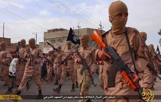 In this photo released on April 25, 2015 by a militant website, which has been verified and is consistent with other AP reporting, young boys known as the "caliphate cubs" hold rifles during a parade after graduating from a religious school in Tal Afar, near Mosul, northern Iraq. (AP)