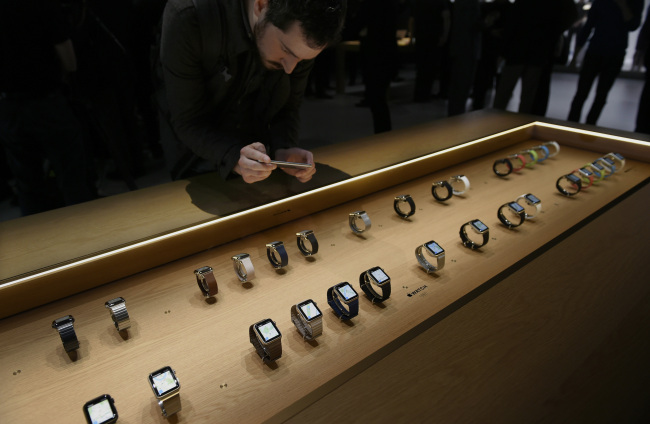 An attendee takes a photograph with an iPhone of the Apple Watches during the Apple Inc. Spring Forward event in San Francisco, California, U.S., on Monday, March 9, 2015. Apple Inc. began showing off features and applications for its first new device in five years, a smartwatch designed to put information on peoples' wrists and break open the fledgling market for wearable technology. Photographer: David Paul Morris/Bloomberg
An attendee takes a photograph with an iPhone of Apple Watches during the Apple Inc. Spring Forward event in San Francisco, California.   Bloomberg
An attendee takes a photograph with an iPhone of Apple Watches during the Apple Inc. Spring Forward event in San Francisco, California.   Bloomberg