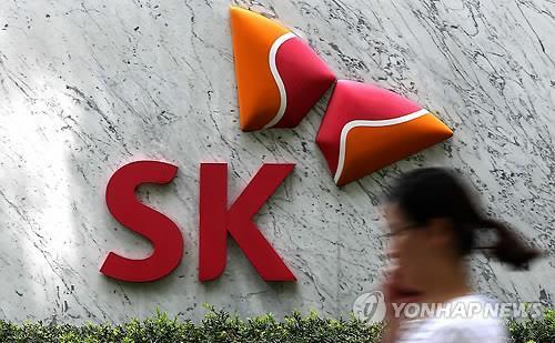 A woman walks by the SK Group headquarters in Seoul. (Yonhap)