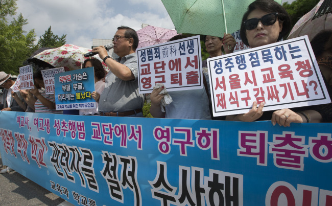 Members of a parents’ group hold a rally protesting the sexual harassment cases of a high school in Seoul in front of the Seoul Metropolitan Office of Education in downtown Seoul last Thursday. Yonhap