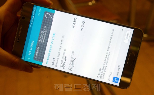 갤럭시노트5의 화면 하단 중앙부를 손가락으로 쓸어올리면 카드가 뜬다. 홈버튼에 손가락을 갔다대면 지문 인식을 통해 결제 가능상태가 된다.
사진=박현구 기자 phko@heraldcorp.com