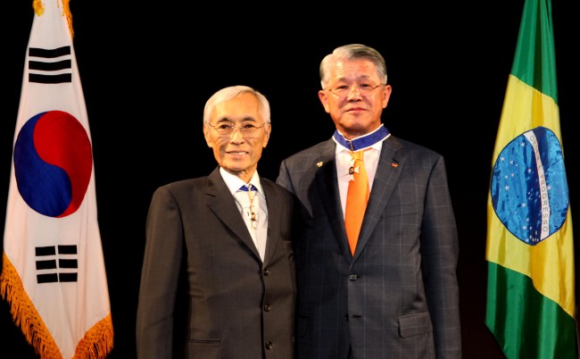 HONOR FROM BRAZIL -- SKC chairman Choi Shin-won (right) poses with former Brazilian ambassador to South Korea Edmundo Fujita after receiving the Order of Rio Branco in a ceremony in Seoul on Wednesday. Choi has become the fourth Korean, after U.N. Secretary-General Ban Ki-mun, former POSCO chairman Lee Koo-taek and Hyundai Group chairwoman Hyun Jeong-eun, to receive this high honor for his role in advancing business ties and cultural exchange between Korea and Brazil.    SKC
　