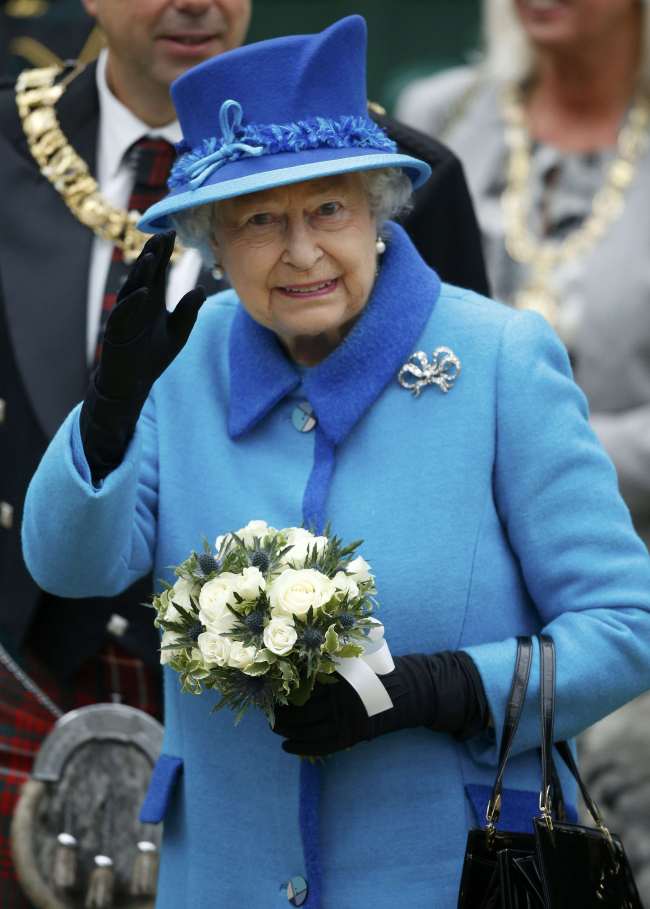 Britain's Queen Elizabeth waves as she arrives at Edinburgh Waverley Station before boarding a train drawn by a steam locomotive to travel along the Scottish Borders Railway in Scotland, Britain, Sept. 9. Reuters