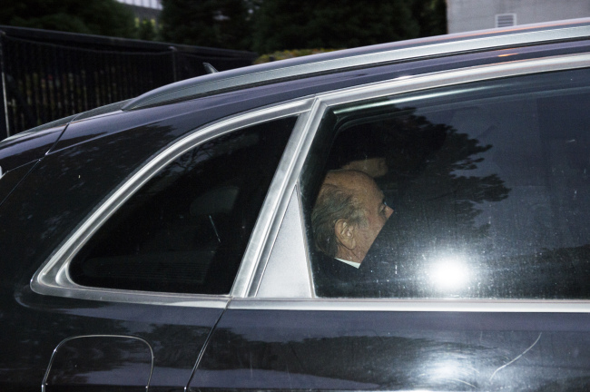 Outgoing FIFA President Sepp Blatter sits in the back of a car as he leaves the FIFA headquarters in Zurich, Switzerland, Thursday after he was provisionally banned for 90 days by FIFA ethics committee. (AP)