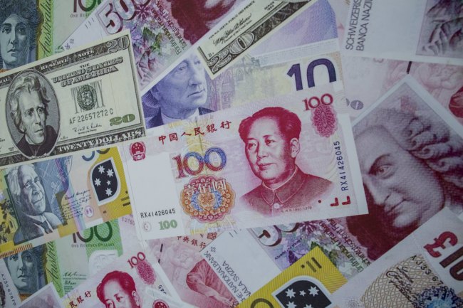An advertisement poster promoting China's renminbi or yuan , U.S. dollar and Euro exchange services is seen outside at foreign exchange store in Hong Kong, China in this August 13, 2015 file photo. Reuters-Yonhap News