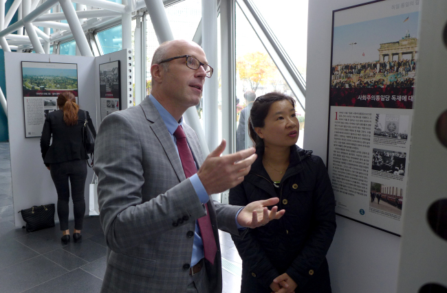 German embassy first secretary Markus Hatzelmann (left) and embassy press officer Kim Tae-young observe an exhibition commemorating the 25th anniversary of German reunification at the Seoul City Hall lobby on Nov. 16.
Joel Lee/The Korea Herald