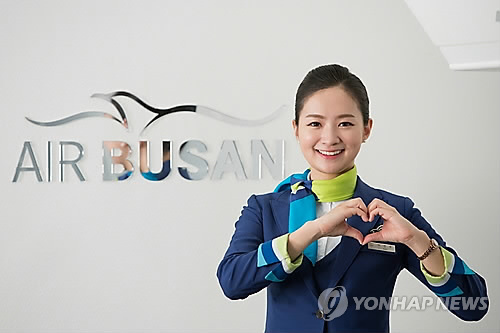 A model poses to promote budget airliner Air Busan. (Yonhap)