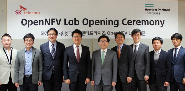 SKT OPENS LAB FOR VR -- SK Telecom launched a research and development center Thursday for virtual reality technology called the OpenNFV Lab together with network equipment firm Hewlett Packard Enterprise in Bundang, Gyeonggi Province. In the photo, Park Jin-hyo (fifth from left), head of SKT’s network technology research and development center, poses with officials from both firms at the opening ceremony of the lab.(SKT)