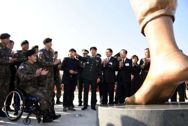 Hyosung president Cho Hyun-joon (fourth from right) and military officers applaud at the installation ceremony of the artwork, “The Foot of Peace,” at Nuri Peace Park in Imjingak on Wednesday.   Hyosung Group