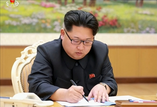 North’s Korean Central TV Broadcasting Station reported in a special broadcast that North Korea has successfully conducted a hydrogen nuclear device test on Wednesday. North Korean leader Kim Jong-un signs an order to conduct the test.   (Yonhap)