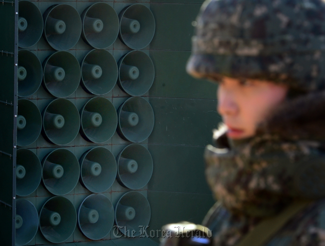 A solder is on the guard nearby a set of loudspeakers reactivated Friday in central Gyeonggi Province. (Yonhap)