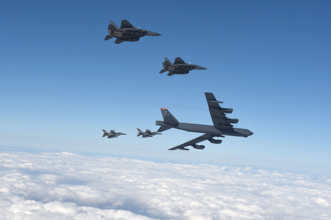 The U.S. B-52 strategic bomber, escorted by four fighter jets, is seen flying over the Korean Peninsula on Sunday. (Yonhap)