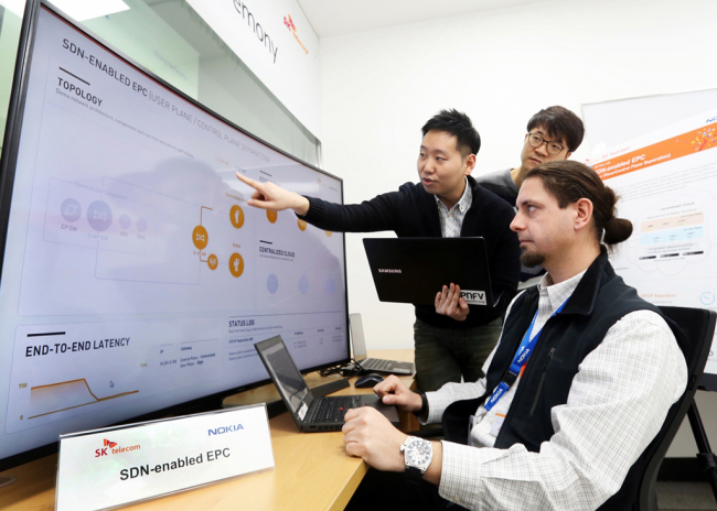 Staffers from SK Telecom and Nokia Networks monitor the wired 5G technology at the 5G Global Innovation Center in Bundang, Gyeonggi Province, on Monday. (SKT)