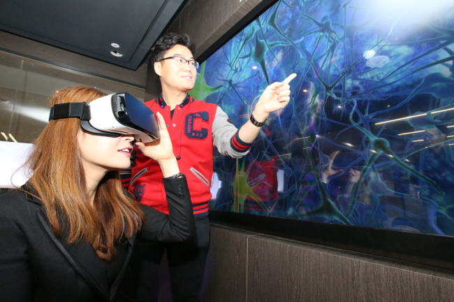 Visitors try out virtual reality headsets at the Center for Creative Economy and Innovation in Pangyo, Gyeonggi Province.   KT