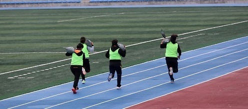 Women applicants run carrying bags weighing 10 kg during a physical test to pick new street cleaners in Gangneung, Gangwon Province, in November, 2015.  Yonhap