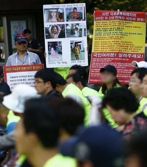 Members of an online website helping the victim of international marriage scams hold a rally calling for legal measures in Seoul in September 2013.  Yonhap