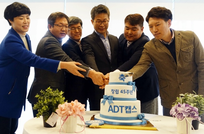 최진환 ADT캡스 대표이사(오른쪽 세 번째)와 장기근속자들이 지난 25일 서울 삼성동 본사 로비에서 진행된 창립 45주년 기념식에서 2016년 고객서비스 No.1으로의 도약을 다지며 케이크 커팅을 진행하고 있다. [사진 제공=ADT캡스]
최진환 ADT캡스 대표이사(오른쪽 세 번째)와 장기근속자들이 지난 25일 서울 삼성동 본사 로비에서 진행된 창립 45주년 기념식에서 2016년 고객서비스 No.1으로의 도약을 다지며 케이크 커팅을 진행하고 있다. [사진 제공=ADT캡스]