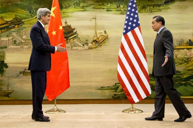 U.S. Secretary of State John Kerry (left) and Chinese Foreign Minister Wang Yi approach to shake hands Wednesday after attending a news conference at the Ministry of Foreign Affairs in Beijing, China. Reuter-Yonhap