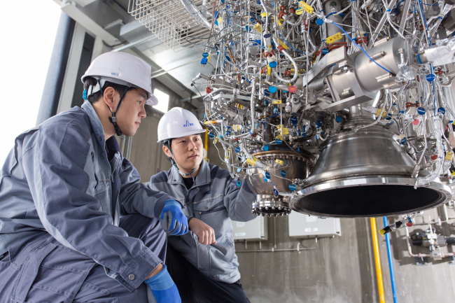 Engineers from the state-run Korea Aerospace Research Institute prepare to test a 7-ton rocket engine.   KARI
