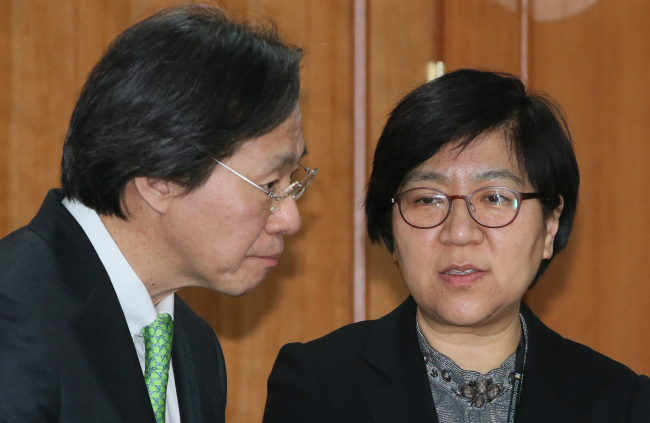 The new chief of the Centers for Disease Control and Prevention Jung Ki-suck talks with Jeong Eun-kyung, head of the emergency team during a government meeting on Zika virus spread in Seoul on Wednesday. (Yonhap)
