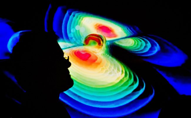 The silhouette of a scientist against a visualisation of gravitational waves pictured during a press conference by the Max Planck Institute for Gravitational쟑hysics (Albert Einstein Institute) at the Leibniz University in Hanover, Germany, 11 February. (EPA)
