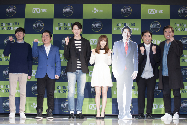 The cast of “We Kid” pose for the press at the AW Convention Center in Seoul on Wednesday. (From left) Producer Kim Shin-young, composer Yoon Il-sang, actor Yoo Yeon-seok, actress Park Bo-young, a cutout of hip-hop artist Tiger JK, composer Yoo Jae-hwan and chief producer Kim Yong-beom. (Mnet)