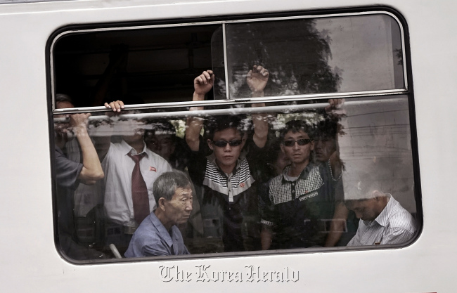 In this Sept. 11, 2015 photo, commuters ride on a crowded city trolley bus in Pyongyang. (AP-Yonhap)