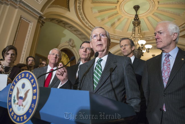 Senate Majority Leader Mitch McConnell (third from right) speaks to reporters on Capitol Hill in Washington on Feb. 9 following a closed-door policy meeting, saying the chamber will consider legislation to hit North Korea with more stringent sanctions in the wake of its recent missile launch.(AP-Yonhap)