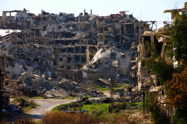 A Syrian man walks through a devastated part of the old city of Homs, Syria, Friday, Feb. 26, 2016. The U.N. Security Council is expected to vote Friday afternoon on a draft resolution endorsing the "cessation of hostilities" in Syria that is set to start at midnight local time. The draft, obtained by The Associated Press, also urges the U.N. secretary-general to resume Syria peace talks "as soon as possible."(Yonhap-AP)