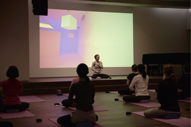 Participants in the D Museum’s yoga class follow yoga poses in January. (D Museum)