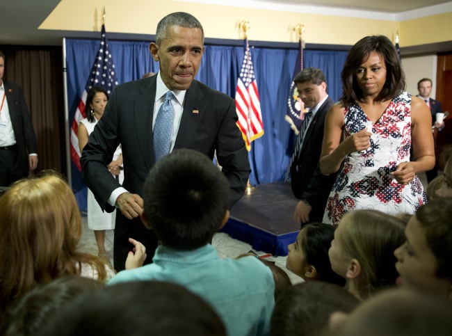 U.S. President Barack Obama and first lady Michelle Obama greet children and families of embassy personnel during an event at Melia Habana Hotel, in Havana, Cuba, Sunday. AP