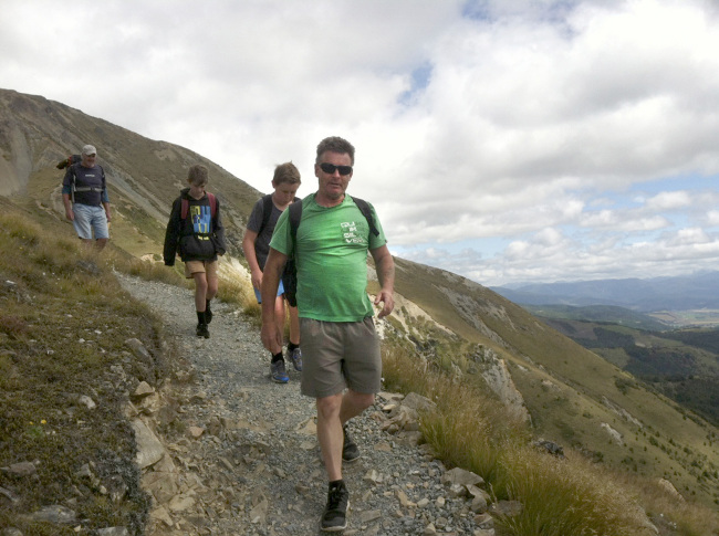Hikers make their way down from Mount Roberts in New Zealand on a trail paved with crushed rock. (Orange County Register/TNS)