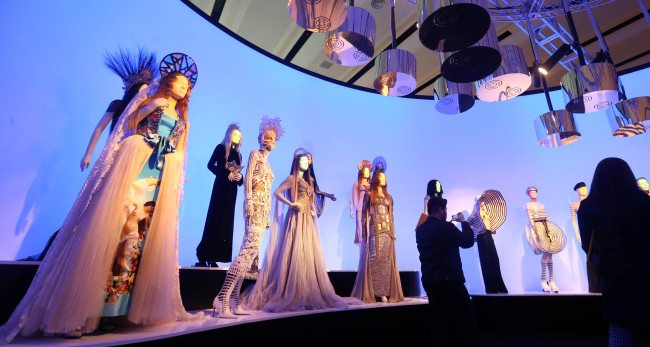 Visitors view works on display at the Jean Paul Gaultier Exhibition at Dongdaemun Design Plaza in Seoul last Friday. (Yonhap)