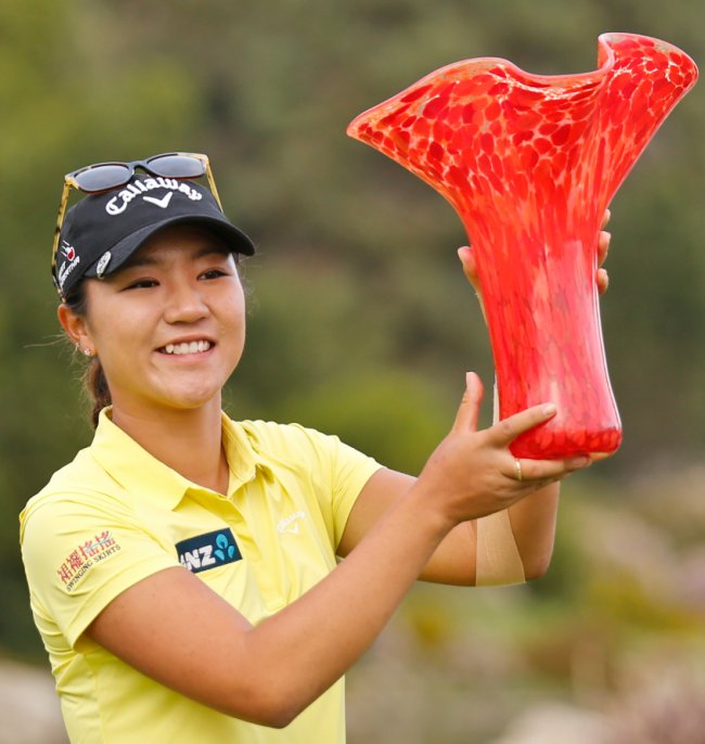Lydia Ko, from New Zealand, holds up the winner's trophy after her four shot victory at the Kia Classic women's golf tournament Sunday in Carlsbad, California. AP