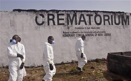 Health workers prepare to collect the ashes of people that died due to the Ebola virus at a crematorium on the outskirts of Monrovia, Liberia. As Liberia marks the second anniversary Wednesday of its first confirmed Ebola cases, many neighbors say they want to see the crematorium torn down so they can try to forget that terrible time. (AP-Yonhap)
