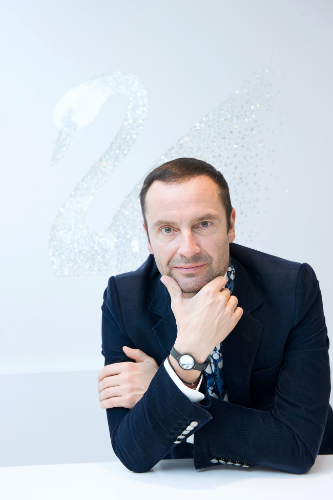 Robert Buchbauer, CEO of Consumer Goods Business of Swarovski, poses in front of the brand’s iconic swan logo at a Swarovski store in Garosugil, Seoul, on Tuesday.(Jang Jong-hoon)