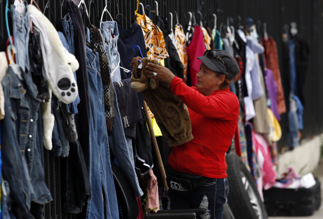 Carmen Salinas sells items at 83rd and Figueroa in Los Angeles on March 5. (Los Angeles Times/TNS)
