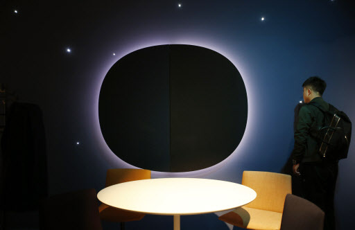 A man views Arper's furniture exposition, part of the design fair, in Milan, Italy. (AP-Yonhap)
