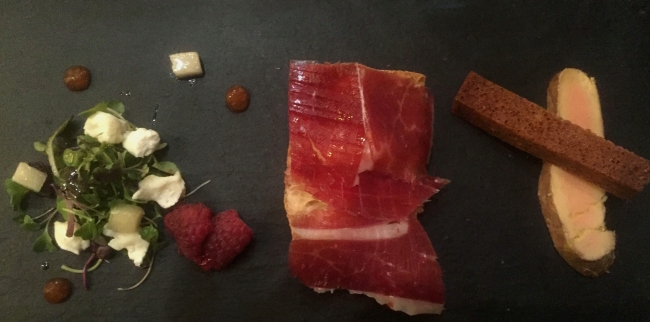 A tasting plate of fruit and goat cheese salad, jamon tapas and foie gras served at the Corral de la Morería dinner and flamenco show. (Julie Jackson/The Korea Herald)