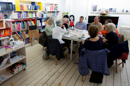 A group of people attend an English class at Bernant bookstore in Barcelona on April 14. (AFP-Yonhap)