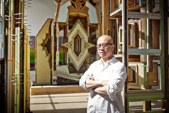 Liu Wei poses in front of “Merely a Mistake.” (Plateau)