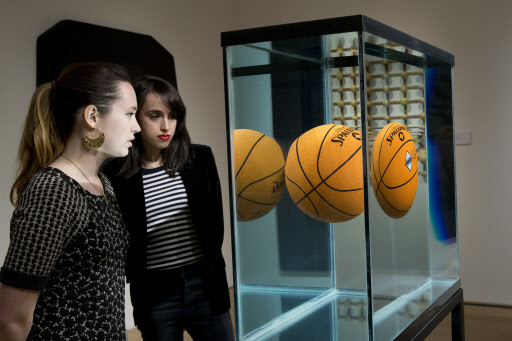 Employees inspect “One Ball Total Equilibrium Tank” by Jeff Koons, on display during the press preview of “Bound to Fail” on April 29 at Christie’s auction house in New York. (AP-Yonhap)