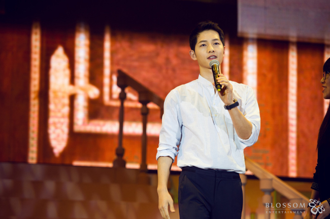 Song Joong-ki speaks at the fan meeting in Beijing on Saturday. (Blossom Entertainment)